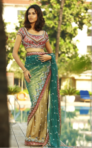 This sari features gold, teal and copper tones.